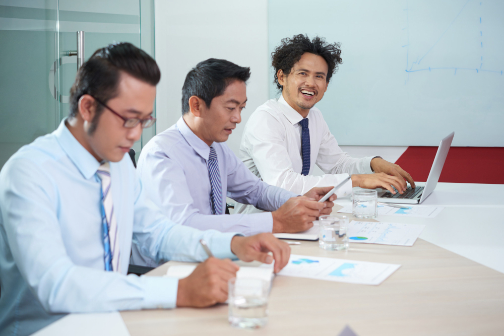 Executives analysing report dashboards in a meeting